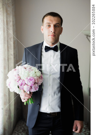 Beautiful man, groom posing and preparing for wedding Beautiful man, groom posing and preparing for wedding 102265884