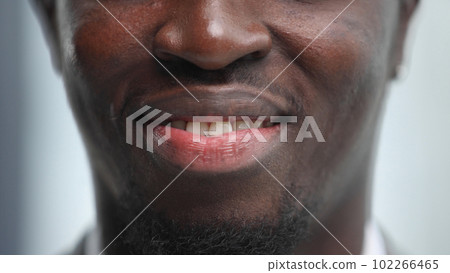 Close-up image of the lips of a black young man Close-up image of the lips of a black young man 102266465