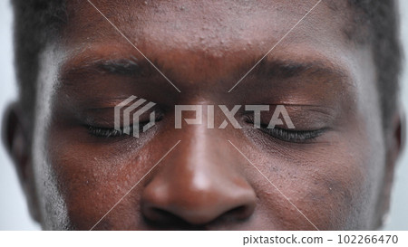 Close up of a Black man's face 102266470