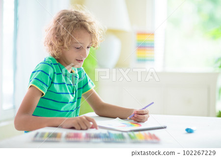 Child drawing. School kid painting a picture. 102267229