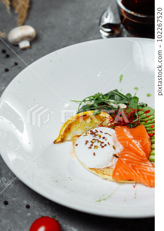 Summer healthy fastfood lunch, breakfast with Pancake with red fish, avocado and egg for breakfast. Aesthetic still life, healthy food concept Summer healthy fastfood lunch, breakfast with Pancake with red fish, avocado and egg for breakfast. Aesthetic still life, healthy food concept 102267520