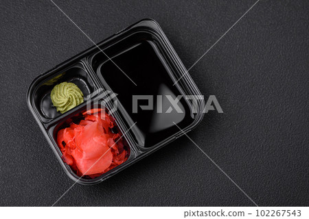 Pickled ginger, soy sauce and wasabi in portioned plastic containers Pickled ginger, soy sauce and wasabi in portioned plastic containers 102267543