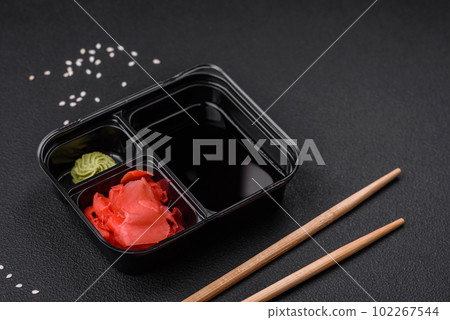 Pickled ginger, soy sauce and wasabi in portioned plastic containers 102267544
