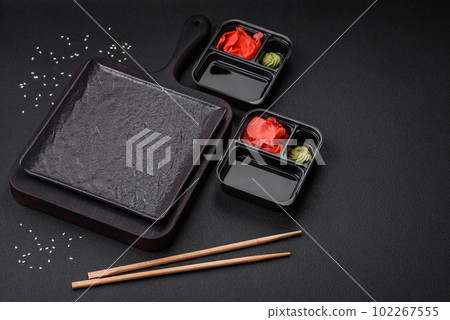 Pickled ginger, soy sauce and wasabi in portioned plastic containers 102267555