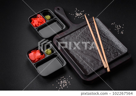 Pickled ginger, soy sauce and wasabi in portioned plastic containers Pickled ginger, soy sauce and wasabi in portioned plastic containers 102267564