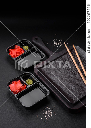 Pickled ginger, soy sauce and wasabi in portioned plastic containers 102267566