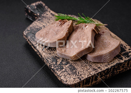 Delicious boiled beef tongue sliced with vegetables and spices Delicious boiled beef tongue sliced with vegetables and spices 102267575