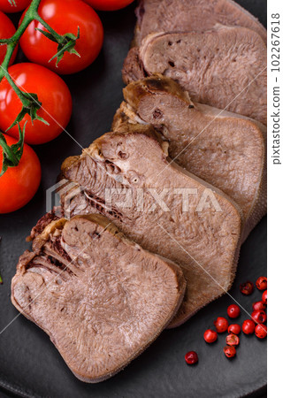Delicious boiled beef tongue sliced with vegetables and spices Delicious boiled beef tongue sliced with vegetables and spices 102267618