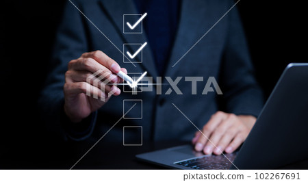 Businessman using laptop doing online checklist survey, filling out digital form checklist, take an assessment, business performance checklist, questionnaire, evaluation, online survey, online exam. Businessman using laptop doing online checklist survey, filling out digital form checklist, take an assessment, business performance checklist, questionnaire, evaluation, online survey, online exam. 102267691