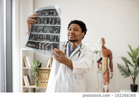 Expert examining CT images in office of outpatient clinic 102268168