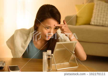Portrait of a woman doing skin care Portrait of a woman doing skin care 102270111