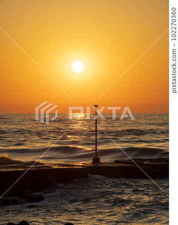 The sun and streetlights sinking into the horizon The sun and streetlights sinking into the horizon 102270360