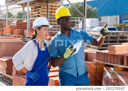 Male manager giving instructions to a female worker Male manager giving instructions to a female worker 102270597