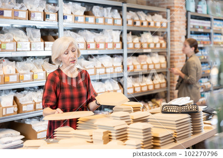Elderly woman chooses blanks for making pottery Elderly woman chooses blanks for making pottery 102270796