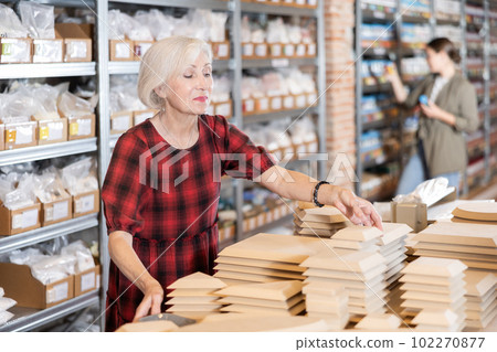 Elderly woman chooses blanks for making pottery Elderly woman chooses blanks for making pottery 102270877