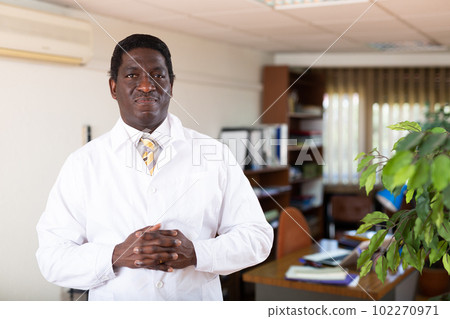 Professional african american doctor standing in medical office 102270971