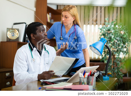 Male doctor and female nurse having productive day Male doctor and female nurse having productive day 102271020