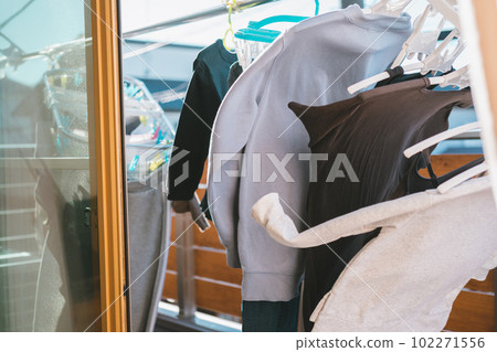 The laundry dried on the veranda sways in the strong wind 102271556