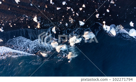 Melting Arctic Ice in Ocean Water, Blue Glacier Ice with Snow on Black Volcanic Beach in Iceland. Climate Crisis 102271794