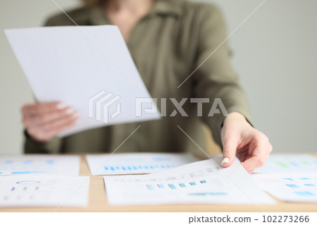 Secretary sorts investigation papers at workplace in office Secretary sorts investigation papers at workplace in office 102273266