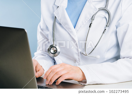 midsection of female doctor using her laptop in the office. Medical appointment or doctors online consultation. Telemedicine midsection of female doctor using her laptop in the office. Medical appointment or doctors online consultation. Telemedicine 102273495