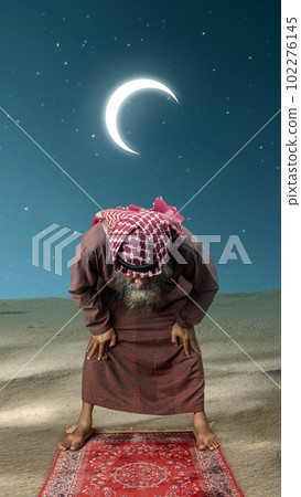 Muslim man with a beard wearing keffiyeh with agal in praying position (salat) on the prayer rug Muslim man with a beard wearing keffiyeh with agal in praying position (salat) on the prayer rug 102276145
