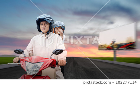 Asian Muslim family carrying a box on a motorcycle going mudik 102277114