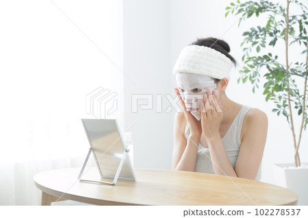 Photo of a woman wearing a face pack Photo of a woman wearing a face pack 102278537