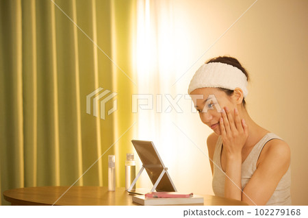 Portrait of a woman doing skin care Portrait of a woman doing skin care 102279168