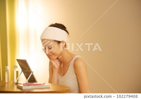 Portrait of a woman doing skin care 102279408