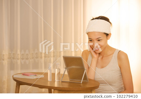 Portrait of a woman doing skin care 102279410