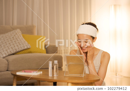 Portrait of a woman doing skin care 102279412