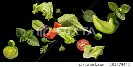 Falling salad leaves isolated on black background Falling salad leaves isolated on black background 102279443
