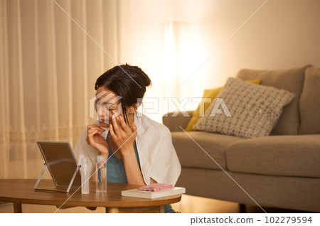 Portrait of a woman doing skin care 102279594