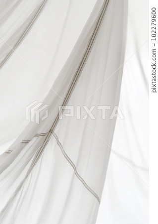 Segment of folded white parachute fabric closeup. Monochrome background with copy space for your design. Segment of folded white parachute fabric closeup. Monochrome background with copy space for your design. 102279600