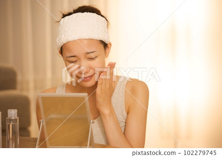 Portrait of a woman doing skin care 102279745