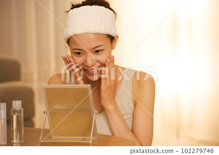 Portrait of a woman doing skin care Portrait of a woman doing skin care 102279746