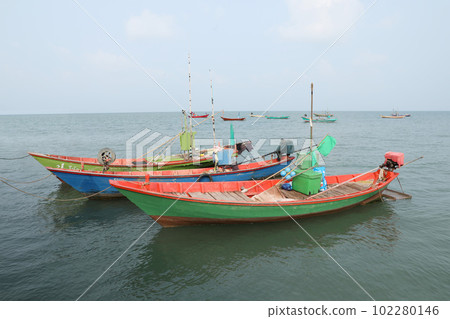 Colorful fishing boat floating on the sea. Colorful fishing boat floating on the sea. 102280146