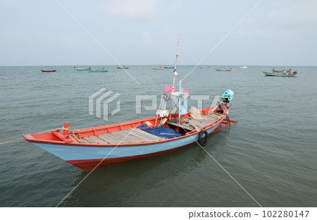 Colorful fishing boat floating on the sea. 102280147