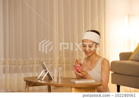 Portrait of a woman doing skin care Portrait of a woman doing skin care 102280561