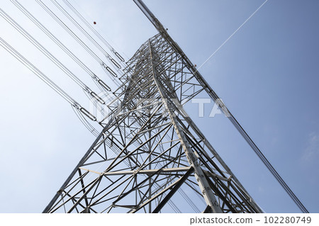 High voltage electric power lines on pylons with blue sky background. 102280749