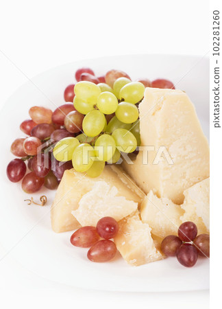 grapes and parmesan. Parmesan cheese and grapes isolated on a white backgroun. View from above grapes and parmesan. Parmesan cheese and grapes isolated on a white backgroun. View from above 102281260