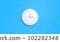 Clock on wall. White wall clock isolated on blue background.  102282348