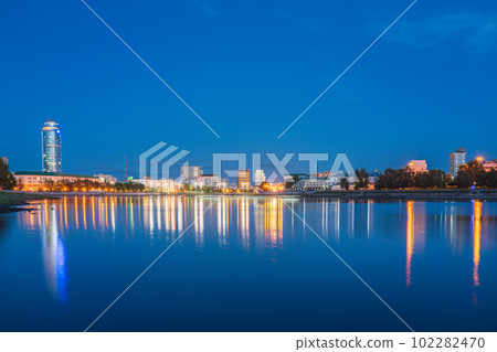 Summer Night on a pond in the center of the city. Yekaterinburg city and pond at night. Summer Night on a pond in the center of the city. Yekaterinburg city and pond at night. 102282470
