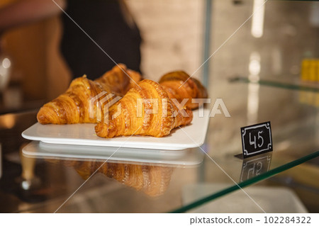 Fresh croissants displayed in bakery window Fresh croissants displayed in bakery window 102284322