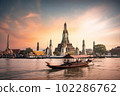 Wat Arun at sunset with long tail boat, in Bangkok, Thailand. Generative AI 102286762