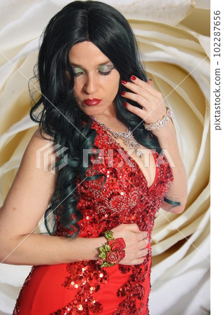 Woman Wearing Formal Red Mermaid Style Gown With Rose 102287656