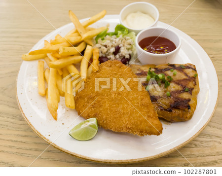 Fish and chips with grilled chicken spicy steak Fish and chips with grilled chicken spicy steak 102287801