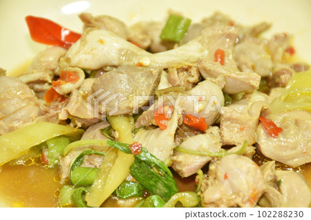 spicy stir-fried chicken gizzard couple liver with yard long bean and chili on plate  102288230