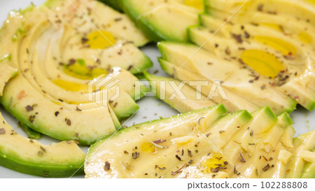 ripe avocado pulp cut into pieces sprinkled with lemon juice on a plate ripe avocado pulp cut into pieces sprinkled with lemon juice on a plate 102288808